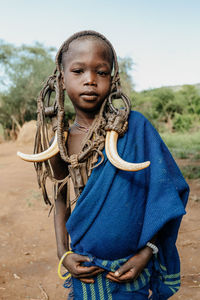 Portrait of girl standing against wall