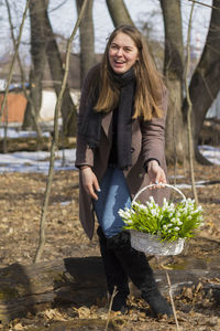 Young woman smiling while standing on land