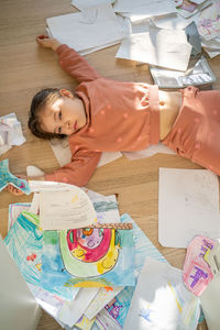 High angle view of cute baby girl lying on bed at home