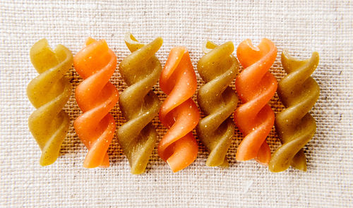 High angle view of orange fruit against white background