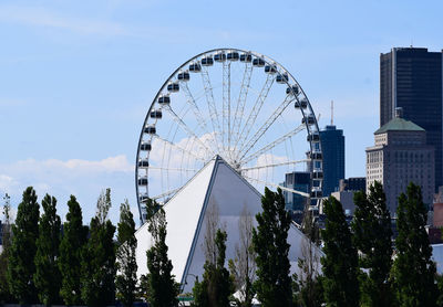 Low angle view of ferris wheel against sky