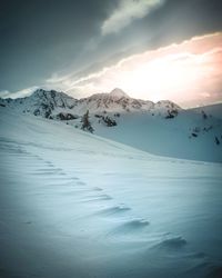 Scenic view of snow covered landscape against sky