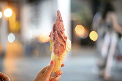 Cropped hand of woman holding ice cream