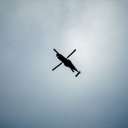 Low angle view of silhouette airplane flying in sky