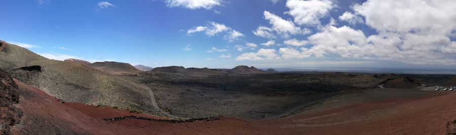 Panoramic view of landscape at timanfaya national park against sky