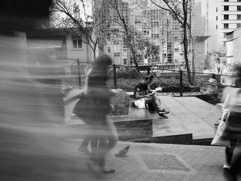 Rear view of a man with woman walking in window