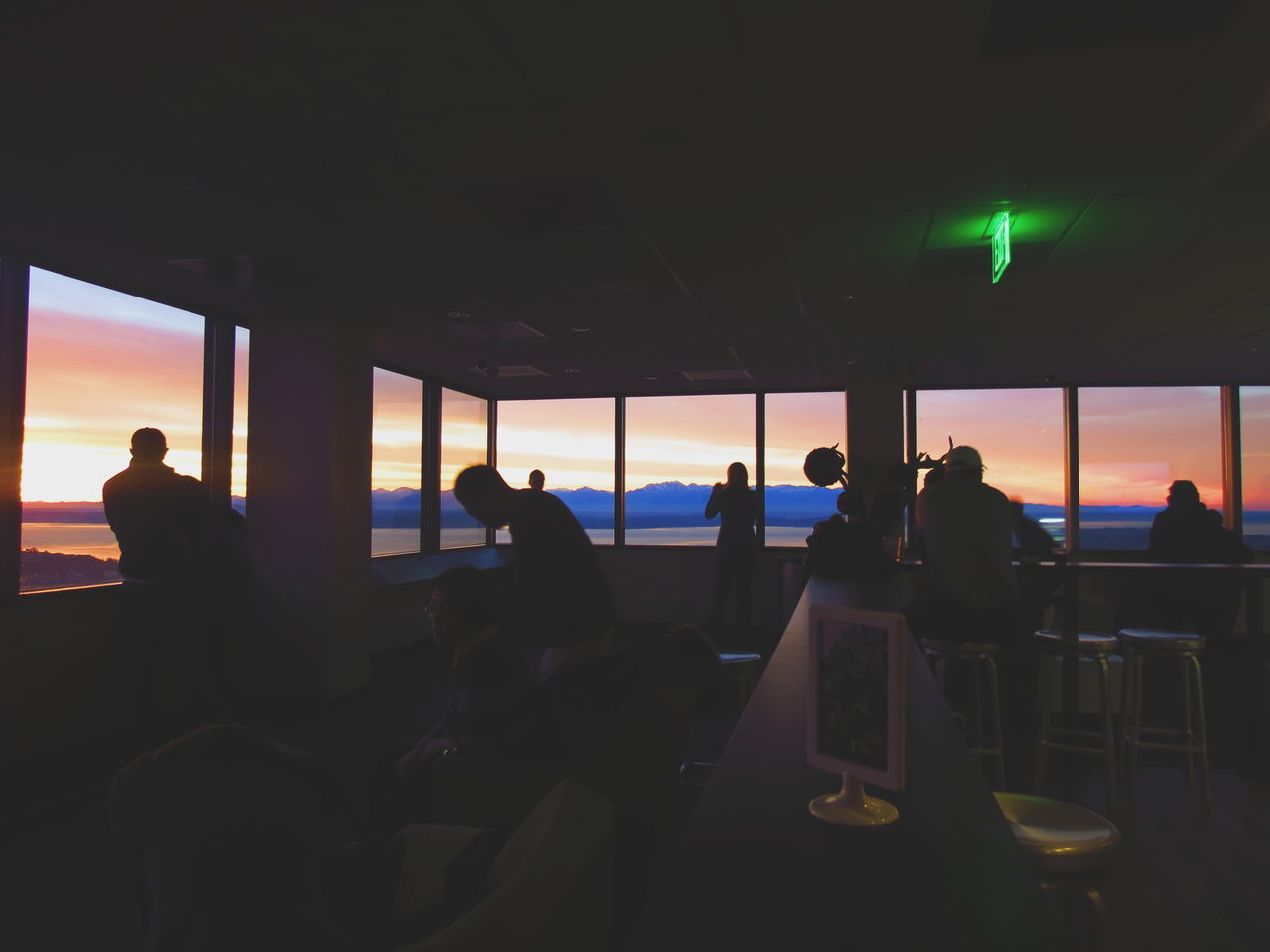 indoors, silhouette, sea, men, chair, horizon over water, window, sitting, sunset, lifestyles, restaurant, leisure activity, person, relaxation, sky, table, glass - material, water, dark