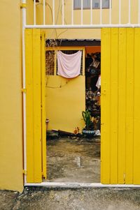 Clothes drying against yellow wall