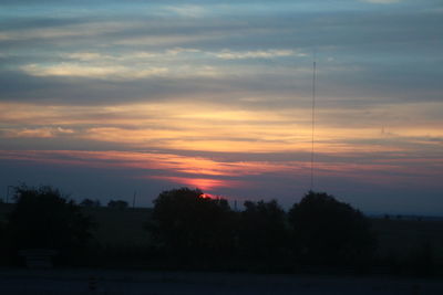 Silhouette trees against sky during sunset