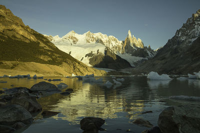 Scenic view of lake and mountains against sky