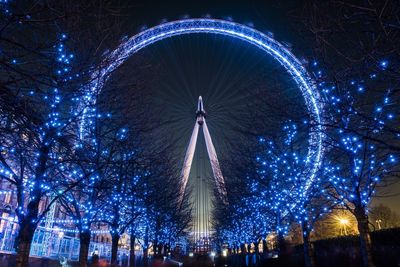 Low angle view of illuminated ferris wheel at night