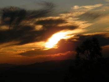 Scenic view of silhouette landscape against orange sky