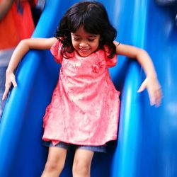 Portrait of happy girl on slide