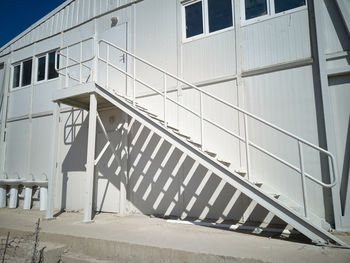 Metal stairway outside of mobile industrial building. newly built two-storey prefabricated building