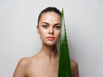 Portrait of beautiful young woman over white background