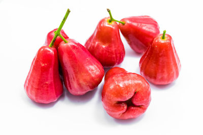 Close-up of cherries over white background