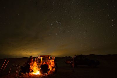 High angle view of fire on field at night