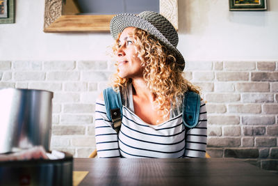 Portrait of a smiling young woman sitting at restaurant