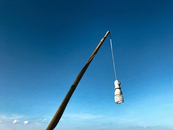 Low angle view of pole against clear blue sky