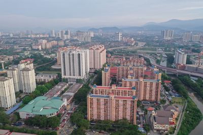 High angle view of buildings in city against sky