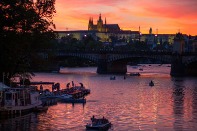 View of boats in river at sunset