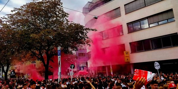 Group of people walking on street in city