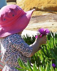 Close-up of woman holding purple flowers