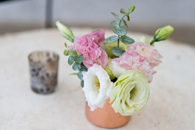 Close-up of pink roses in vase on table