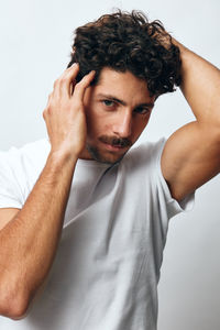 Portrait of man with arms crossed against black background