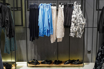 Women's clothes and shoes in a retail shop. fashion and shopping concept