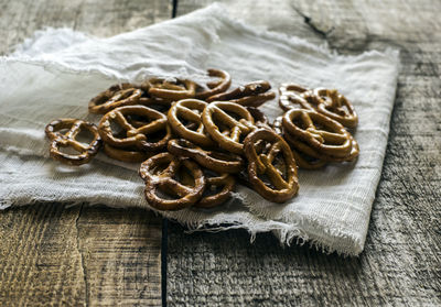 High angle view of wheat pretzels on linen fabric