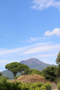 Scenic view of mountains against blue sky