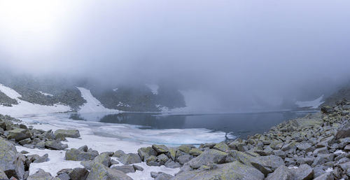 Scenic view of lake against sky during winter