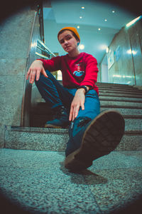 Portrait of man sitting on staircase