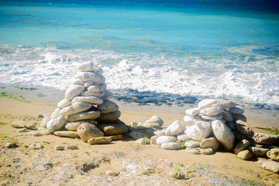 Pile of stone on the beach on the lighthouse phare des baleines on the isle of ile de ré 