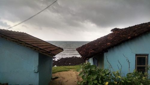 Houses against cloudy sky