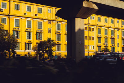 Traffic on road by buildings in city