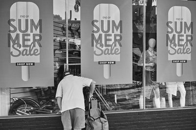 People working on street seen through glass window