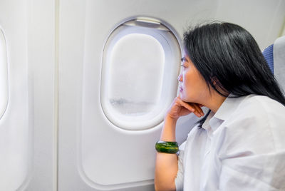 Rear view of boy in airplane