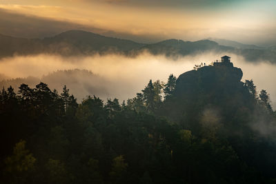 Scenic view of trees and mountains against sky