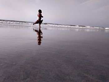 Side view of boy standing on beach