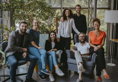 Portrait of smiling male and female colleagues in coworking office