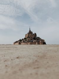 Built structure on beach against sky