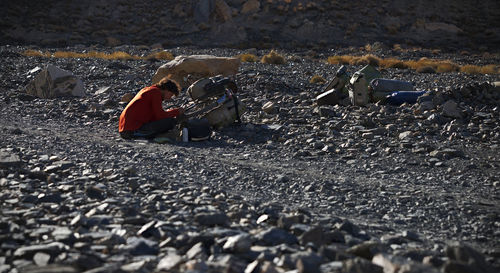 Man repairing bicycle on land