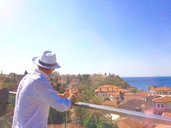 Man standing by sea against clear sky