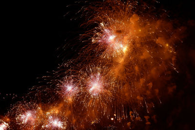 Low angle view of firework display at night