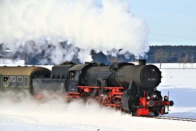 Panoramic view of train against sky during winter