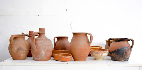 Close-up of objects on shelf against white background