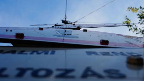 Close-up of cropped boat against blue sky