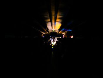 Illuminated tunnel at night